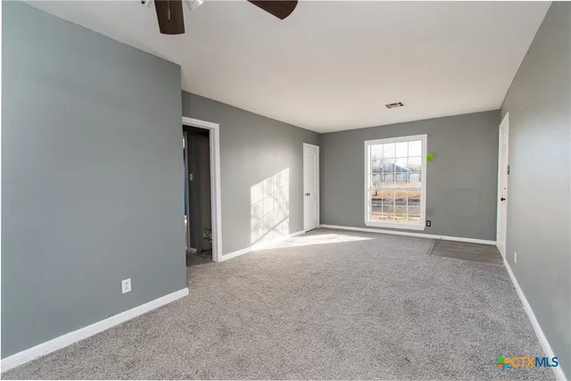 an empty room with windows and closet