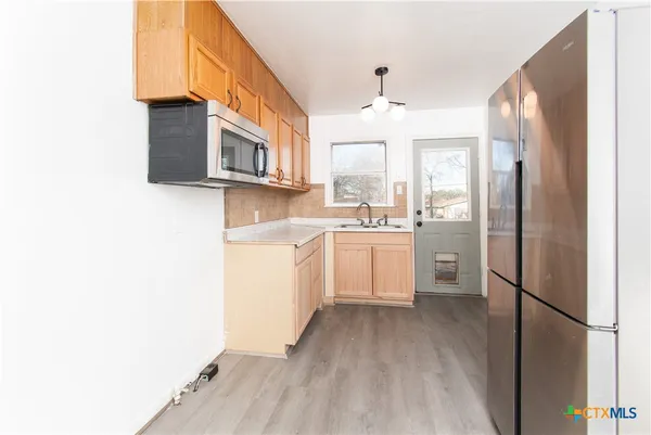 a kitchen with a sink cabinets and stainless steel appliances