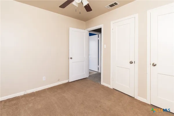 an empty room with a ceiling fan