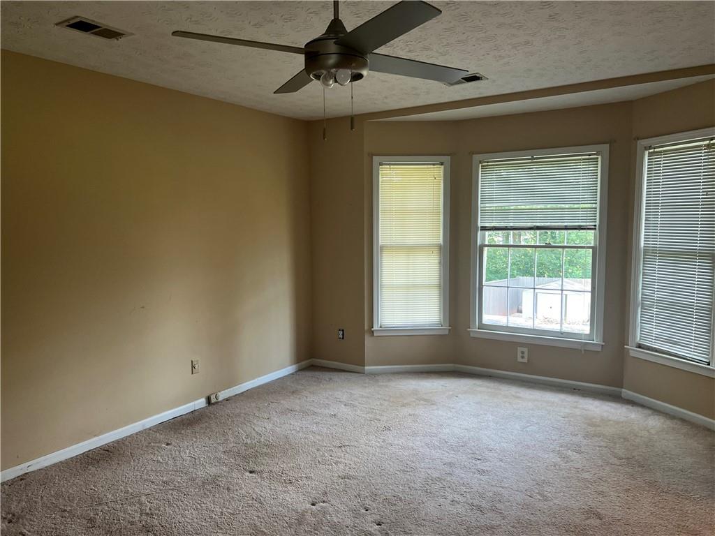 1725 Spindle Top Court Southwest Lilburn, GA 30047 - Photo 13 of 30 a view of an empty room with a window