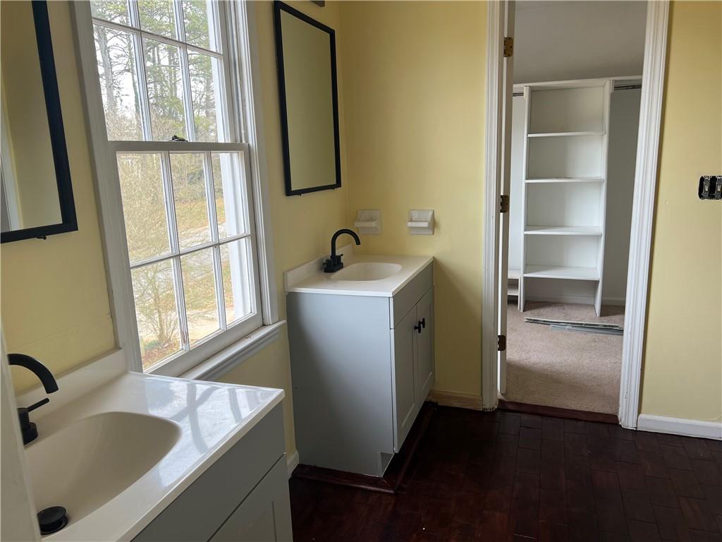 1725 Spindle Top Court Southwest Lilburn, GA 30047 - Photo 14 of 30 a bathroom with a sink and a tub
