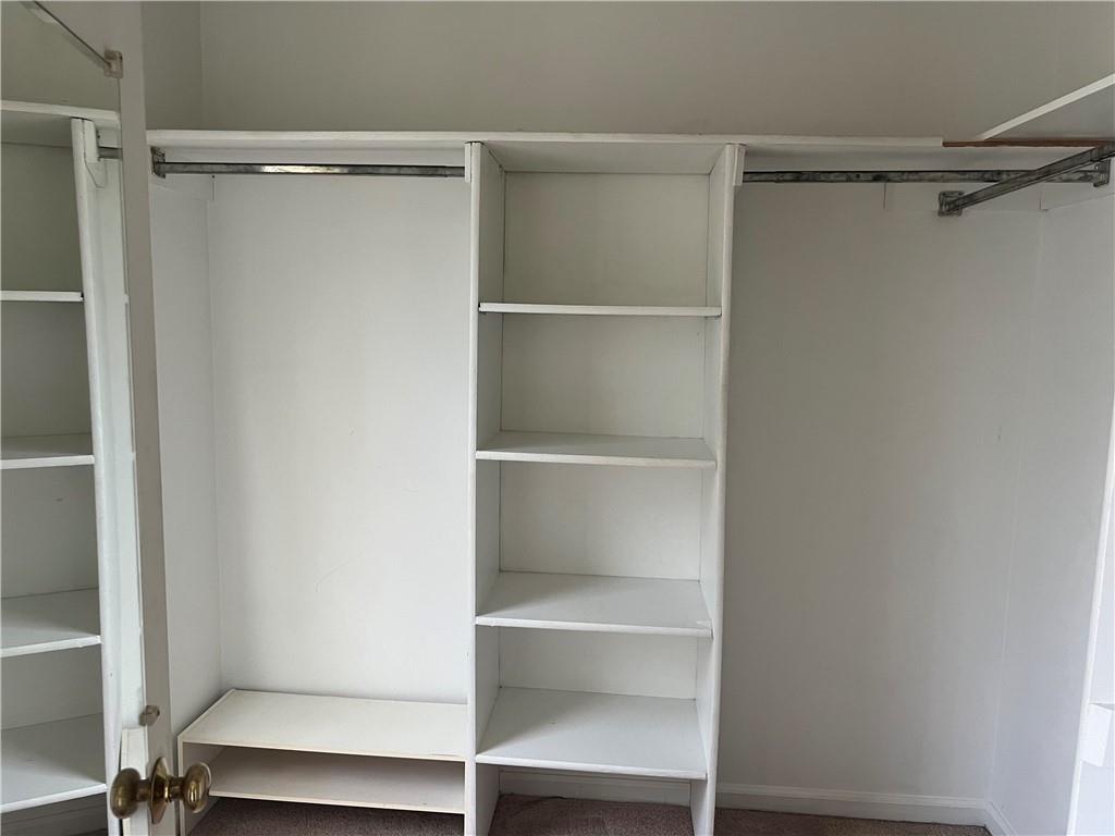 1725 Spindle Top Court Southwest Lilburn, GA 30047 - Photo 16 of 30 a view of an empty walk in closet