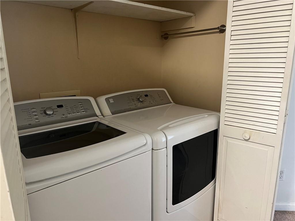 1725 Spindle Top Court Southwest Lilburn, GA 30047 - Photo 21 of 30 a utility room with dryer and washer