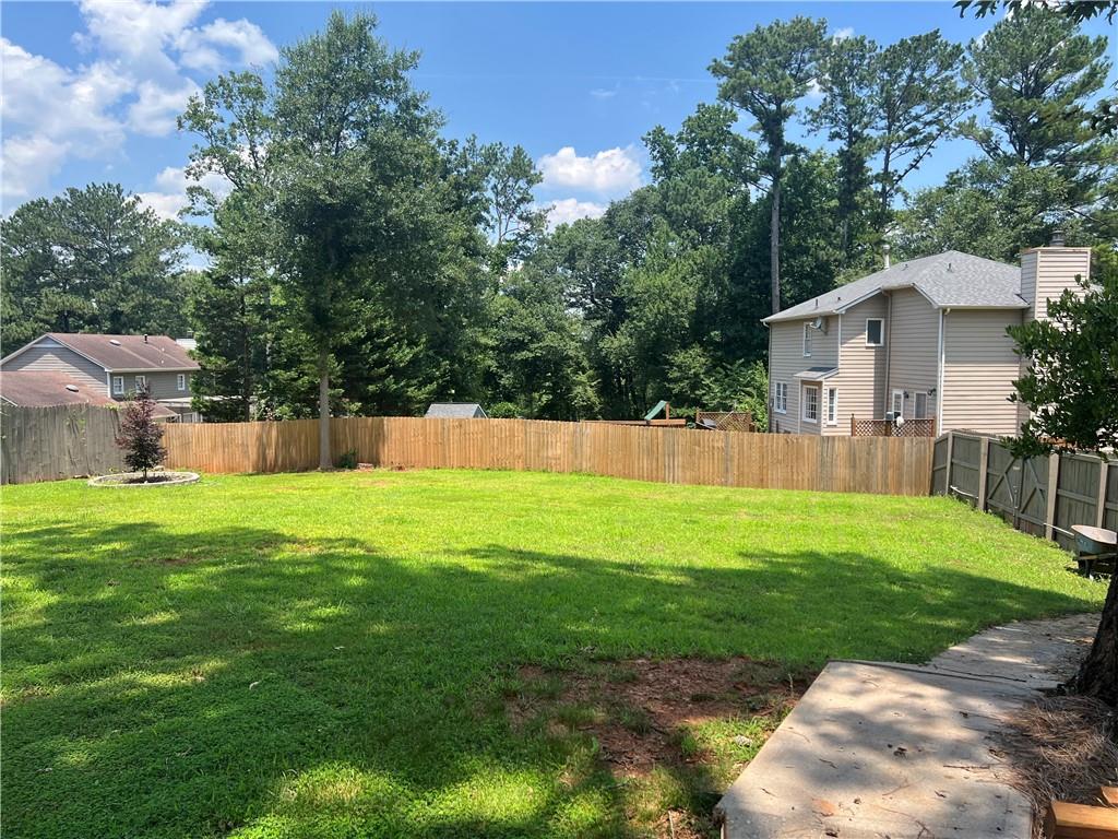1725 Spindle Top Court Southwest Lilburn, GA 30047 - Photo 28 of 30 a view of a house with a yard and sitting area