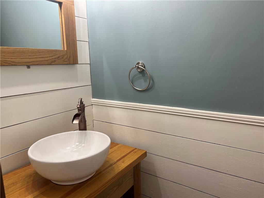 1725 Spindle Top Court Southwest Lilburn, GA 30047 - Photo 7 of 30 a bathroom with a sink and mirror