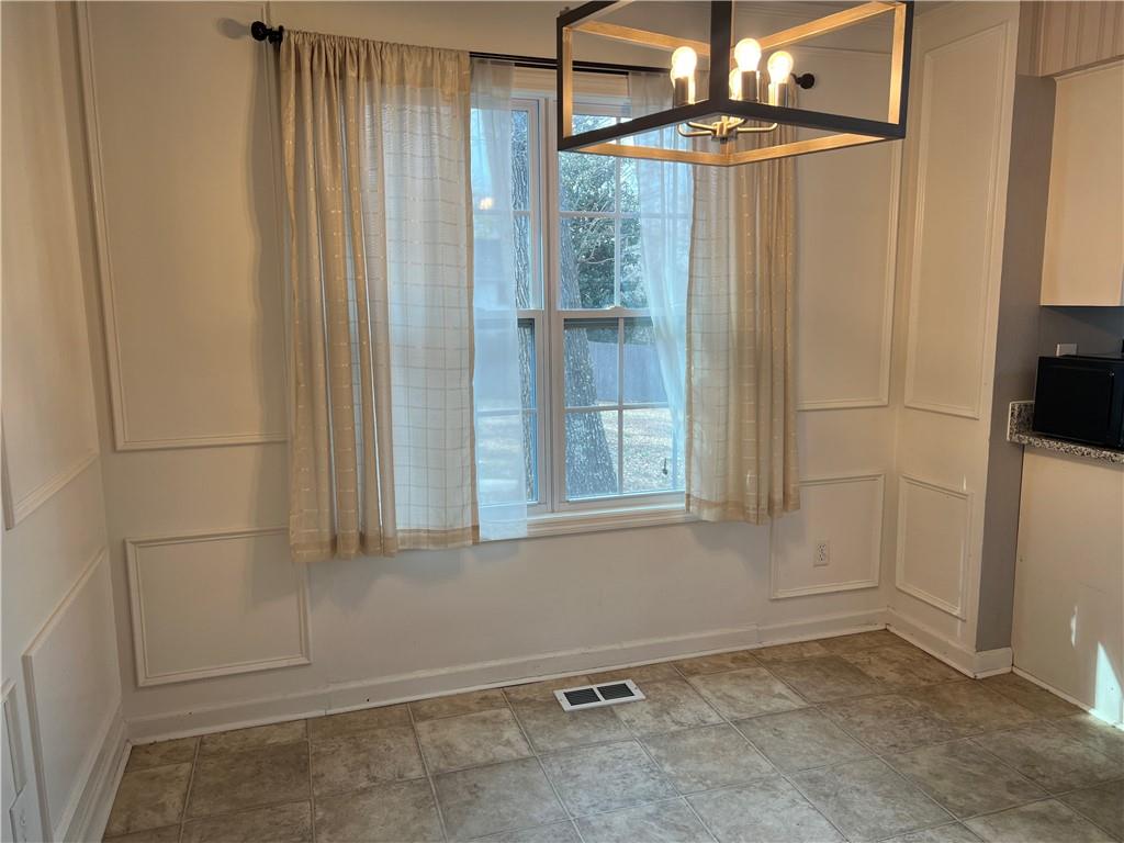 1725 Spindle Top Court Southwest Lilburn, GA 30047 - Photo 10 of 30 a view of an empty room with a fireplace and a window