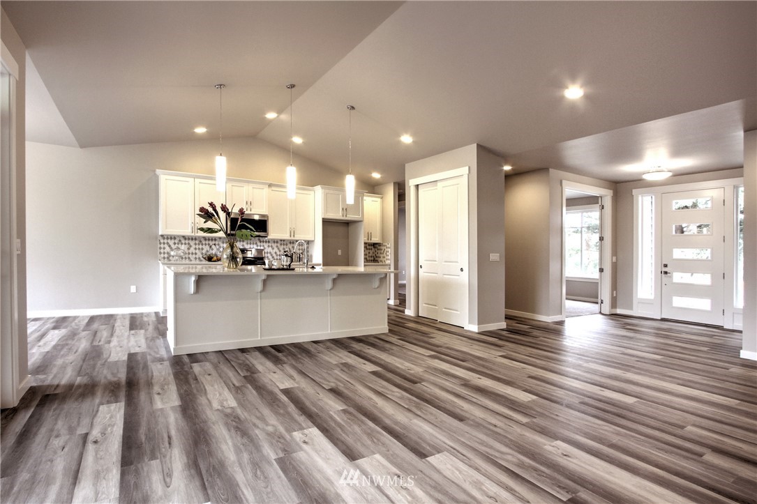3304 Creswell Road, Unit 11 Snohomish, WA 98290 - Photo 3 of 18 a large kitchen with stainless steel appliances kitchen island a large counter top and a wooden floors