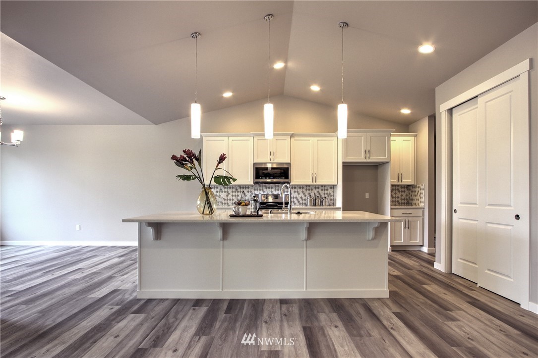 3304 Creswell Road, Unit 11 Snohomish, WA 98290 - Photo 4 of 18 a kitchen with kitchen island a counter top space a sink appliances and cabinets