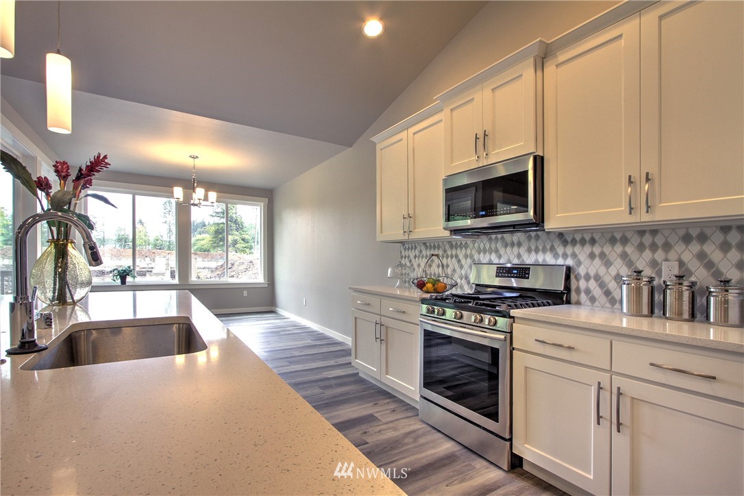 3304 Creswell Road, Unit 11 Snohomish, WA 98290 - Photo 5 of 18 a kitchen with a stove a sink and a microwave