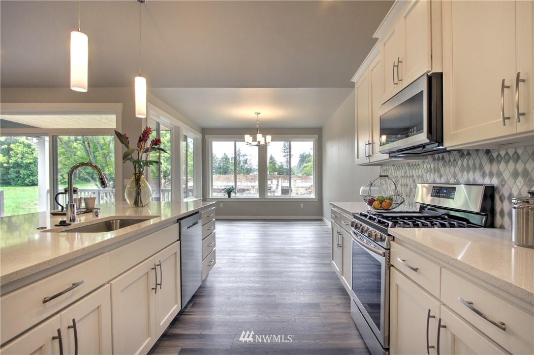 3304 Creswell Road, Unit 11 Snohomish, WA 98290 - Photo 6 of 18 a large kitchen with stainless steel appliances granite countertop a stove a sink and a microwave