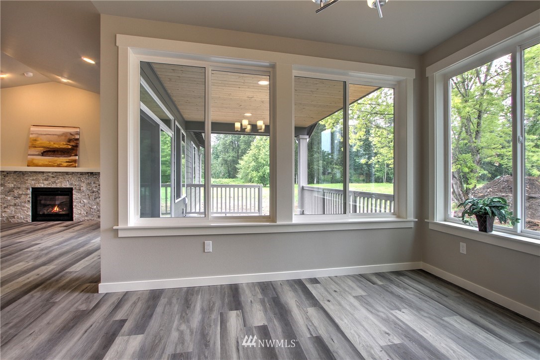 3304 Creswell Road, Unit 11 Snohomish, WA 98290 - Photo 10 of 18 an empty room with wooden floor and windows