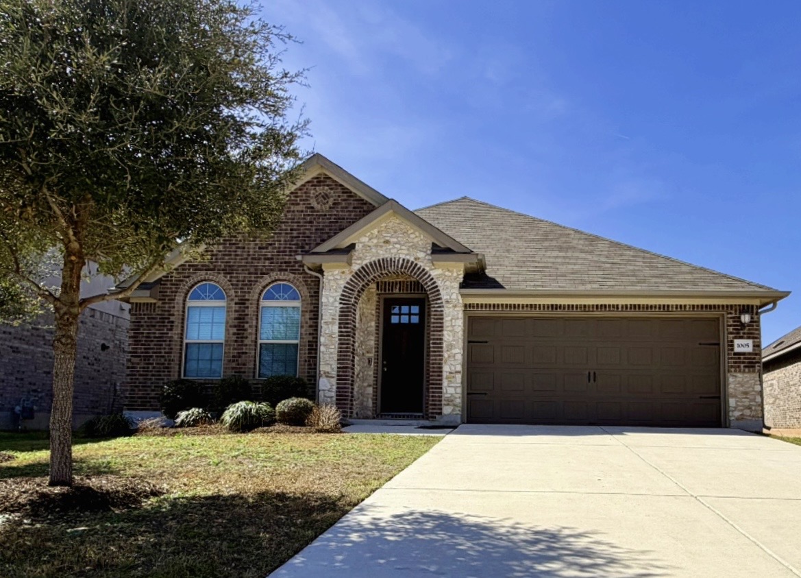 a front view of a house with a yard