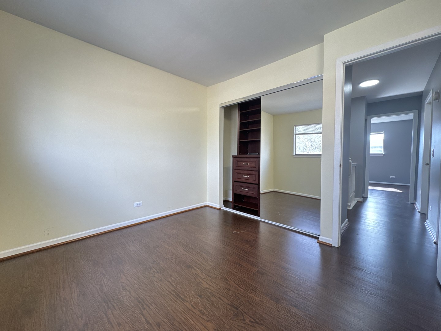 1527 Mohawk Trail Wheeling, IL 60090 - Photo 14 of 21 an empty room with wooden floor and windows