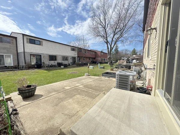 a swimming pool with outdoor seating and yard