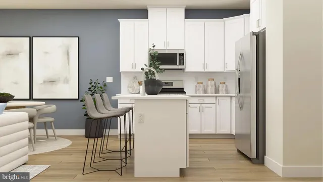 a kitchen with white cabinets and black appliances