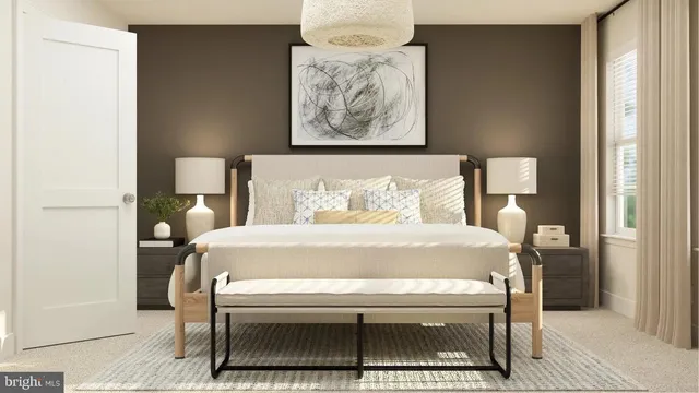 a bed sitting in a bedroom next to a lamp