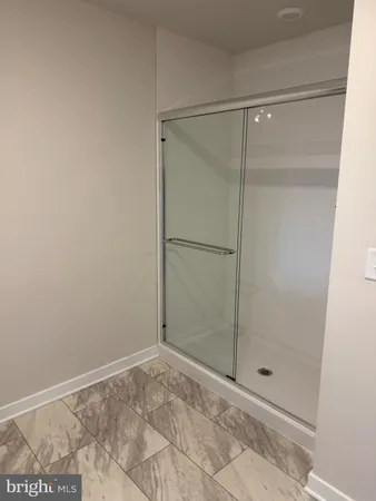 a bathroom with a glass shower door