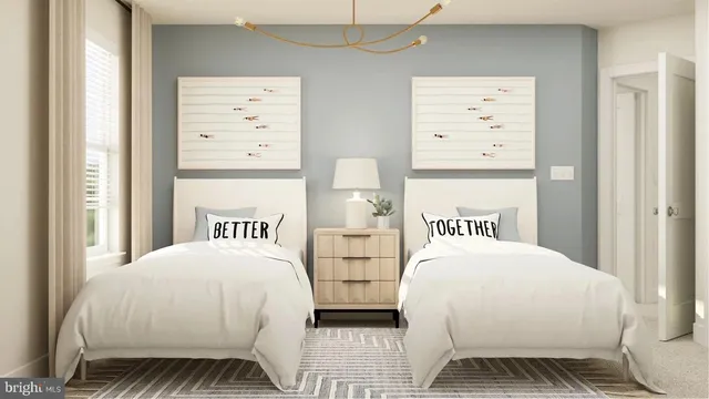 a bedroom with two beds and a window