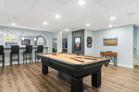 a room with pool table and windows