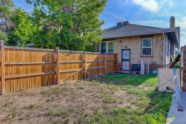 a view of a backyard with wooden fence