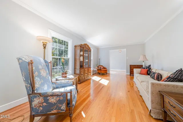 a dining room with furniture a chandelier and wooden floor