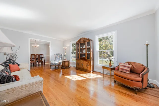 a view of a dining room with furniture and chandelier