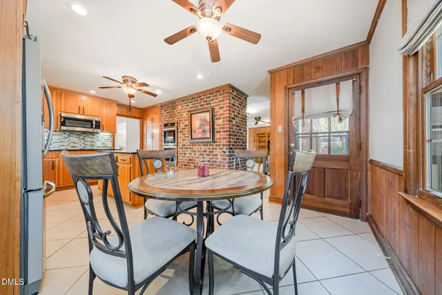 a bedroom with a bed and a dresser next to a window