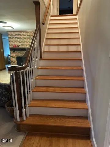 a spacious bedroom with a bed and wooden floor