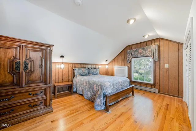 a front view of a house with a yard and tree s