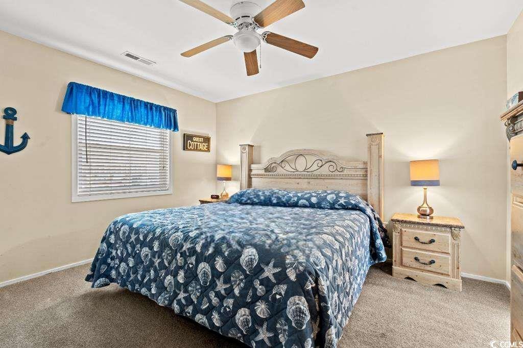9500 Queens Court Myrtle Beach, SC 29572 - Photo 11 of 33 Carpeted bedroom featuring visible vents, baseboards, and ceiling fan