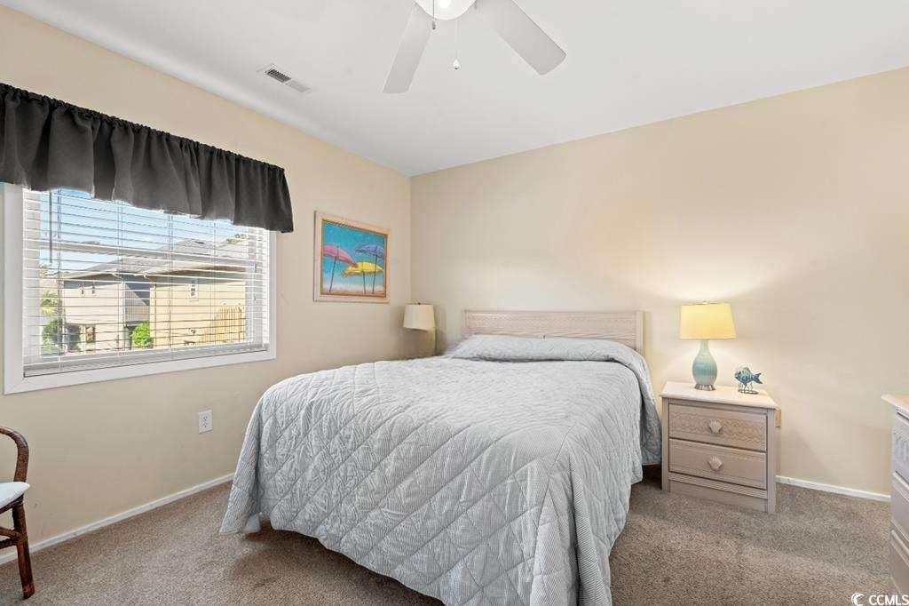 9500 Queens Court Myrtle Beach, SC 29572 - Photo 14 of 33 Bedroom with carpet flooring, visible vents, baseboards, and ceiling fan