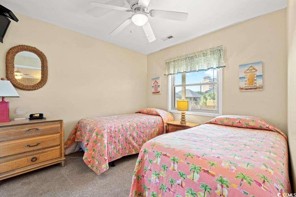 9500 Queens Court Myrtle Beach, SC 29572 - Photo 15 of 33 Carpeted bedroom with ceiling fan and visible vents