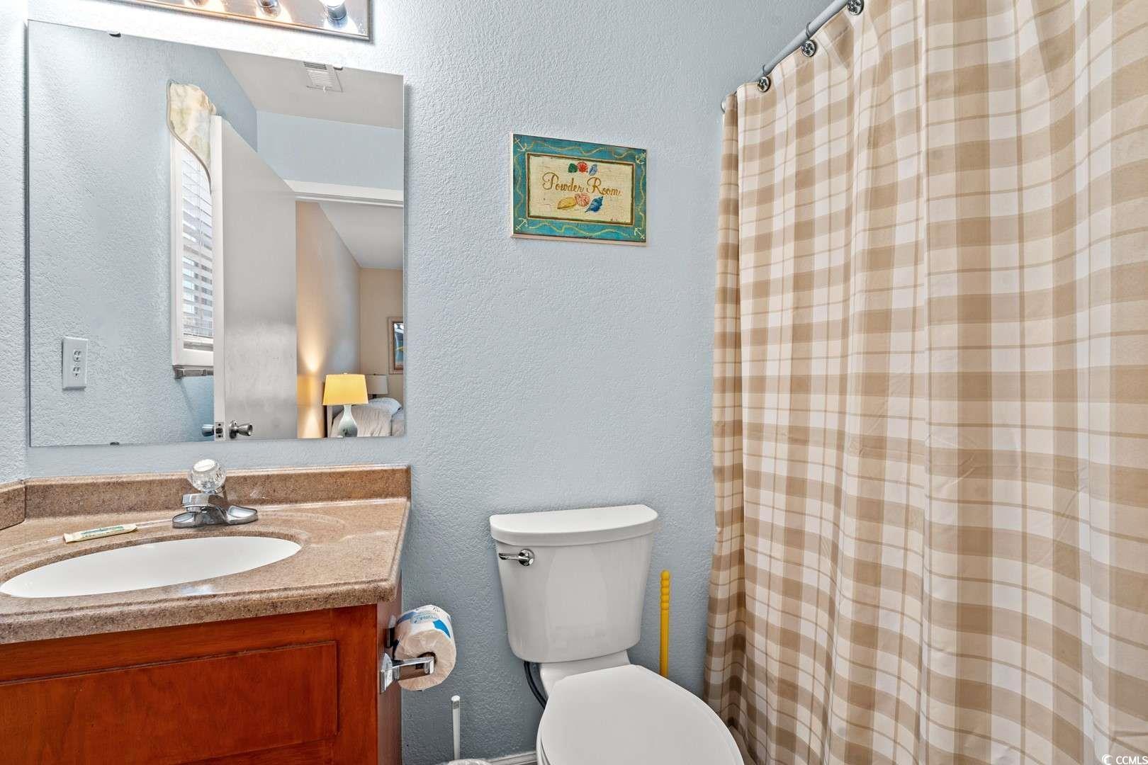 9500 Queens Court Myrtle Beach, SC 29572 - Photo 18 of 33 Full bath with toilet, vanity, visible vents, and a shower with curtain