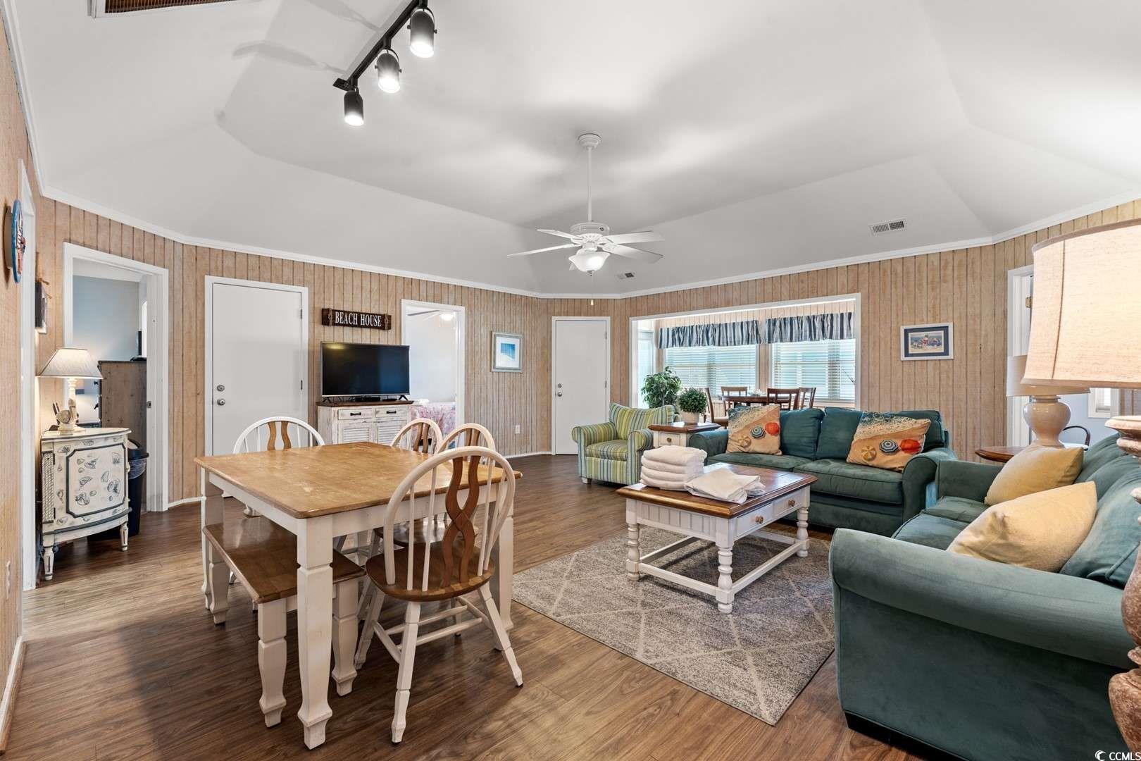9500 Queens Court Myrtle Beach, SC 29572 - Photo 5 of 33 Dining room featuring ornamental molding, visible vents, wood finished floors, and vaulted ceiling