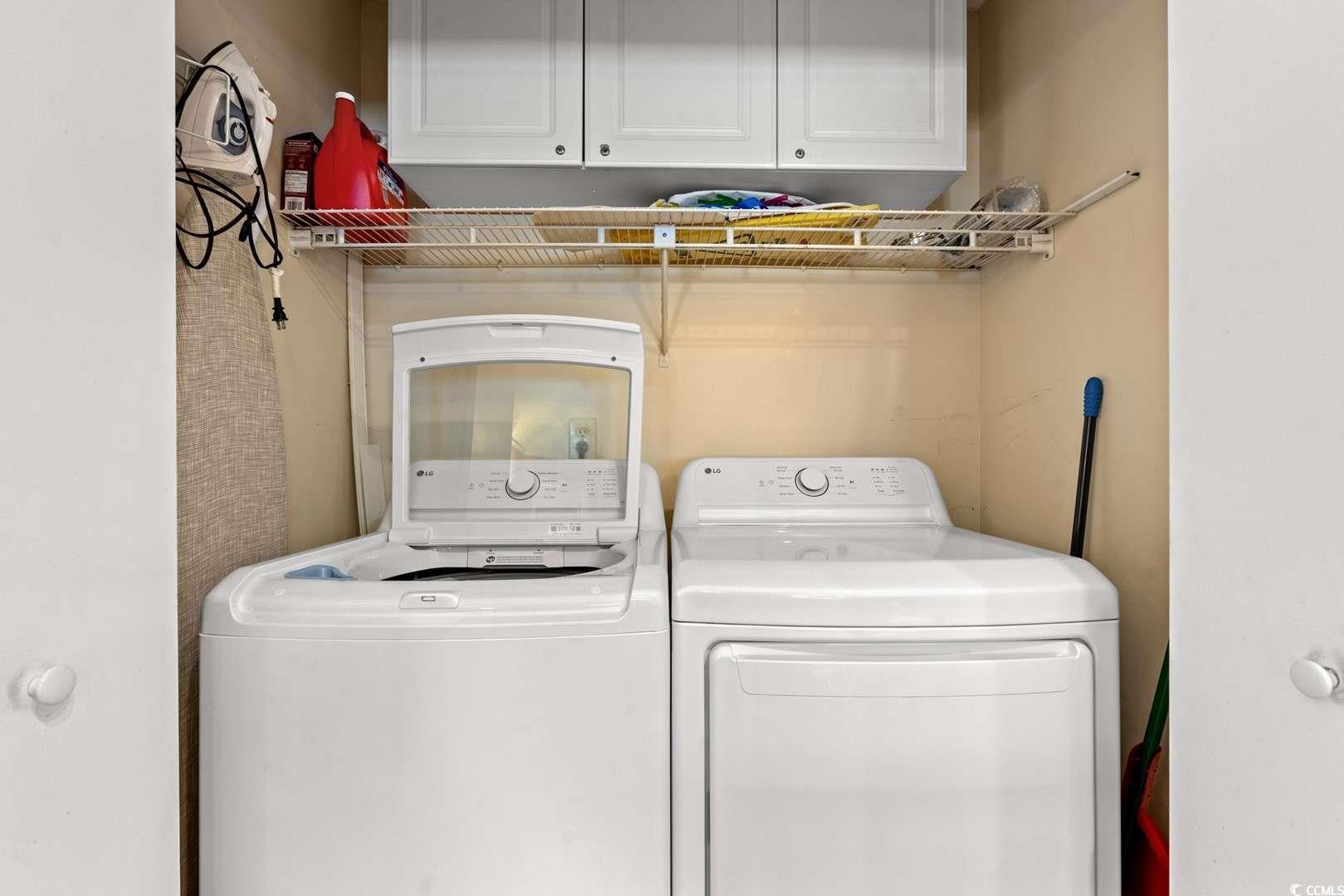 9500 Queens Court Myrtle Beach, SC 29572 - Photo 8 of 33 Laundry area with separate washer and dryer and cabinet space