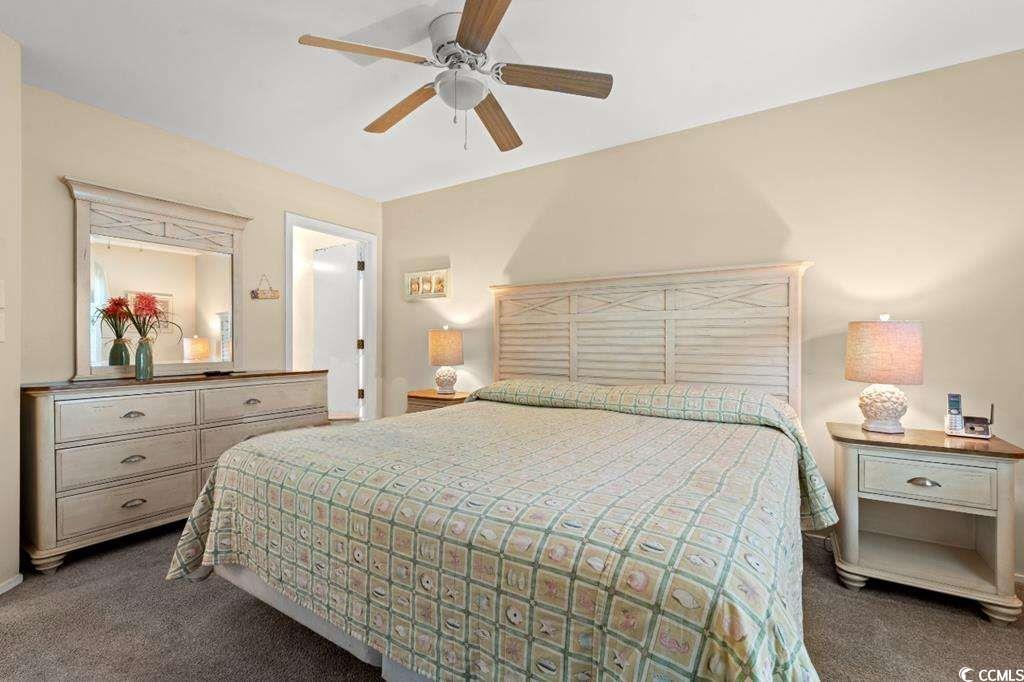9500 Queens Court Myrtle Beach, SC 29572 - Photo 9 of 33 Carpeted bedroom featuring ceiling fan