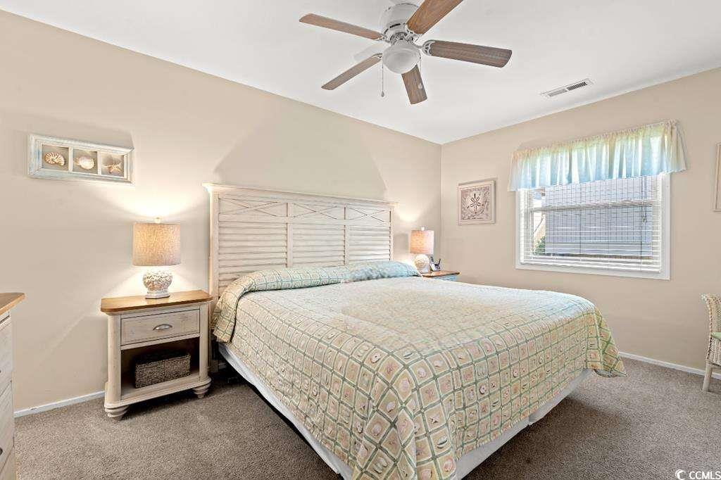 9500 Queens Court Myrtle Beach, SC 29572 - Photo 10 of 33 Carpeted bedroom featuring baseboards, a ceiling fan, and visible vents