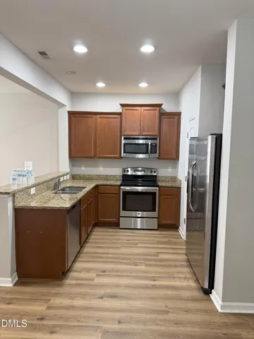 a large kitchen with a stove a sink and a refrigerator