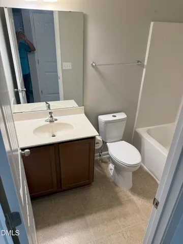 a white toilet sitting next to a bathroom sink
