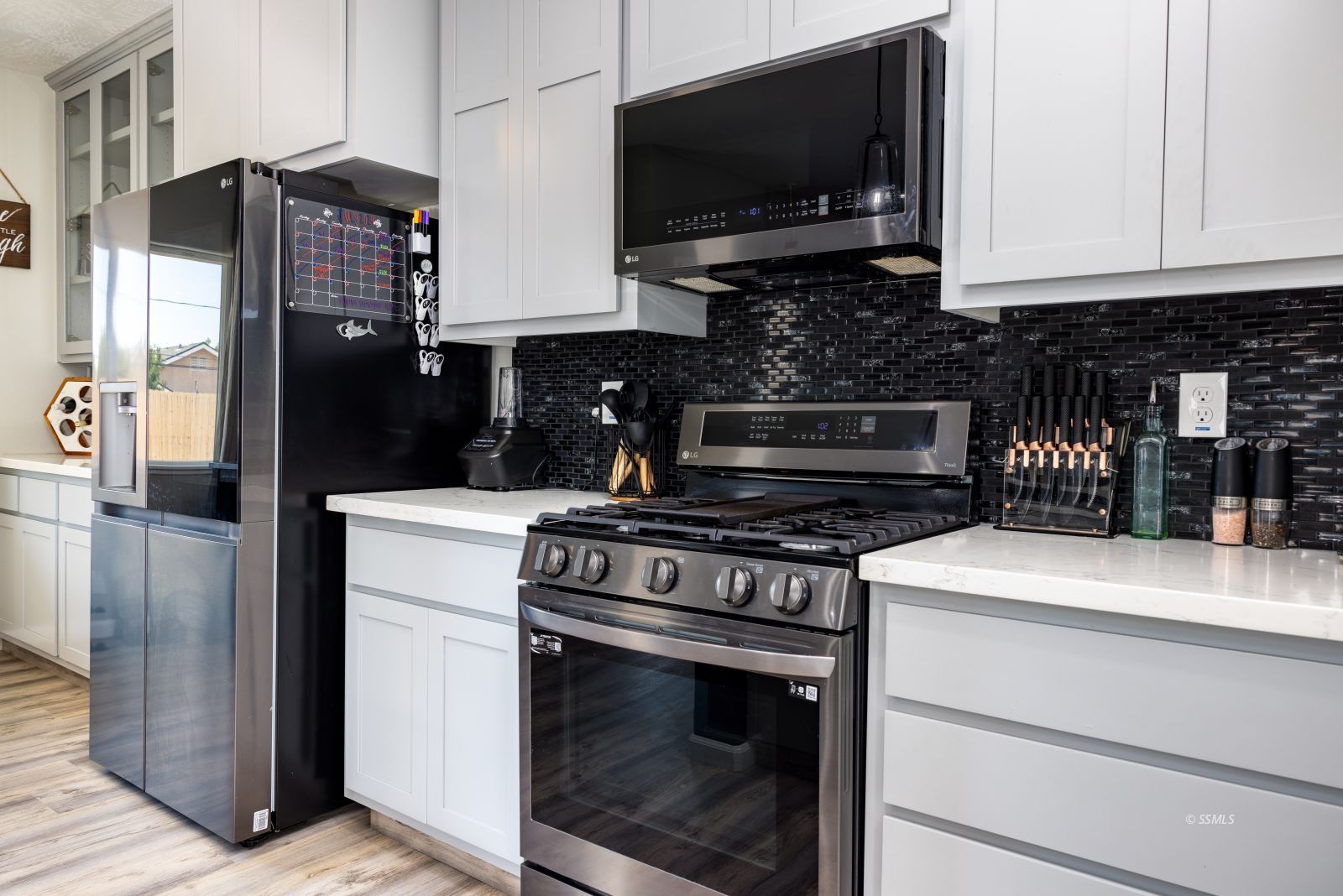 915 West Perch Avenue Ridgecrest, CA 93555 - Photo 15 of 41 a kitchen with stainless steel appliances granite countertop a stove and a microwave