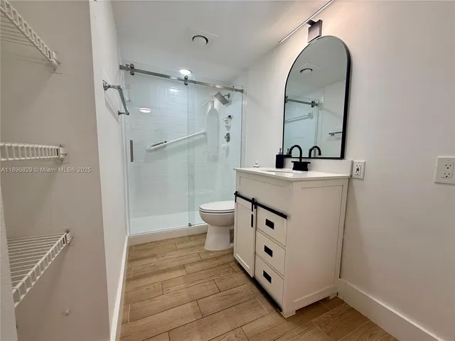 a bathroom with a sink mirror toilet and shower