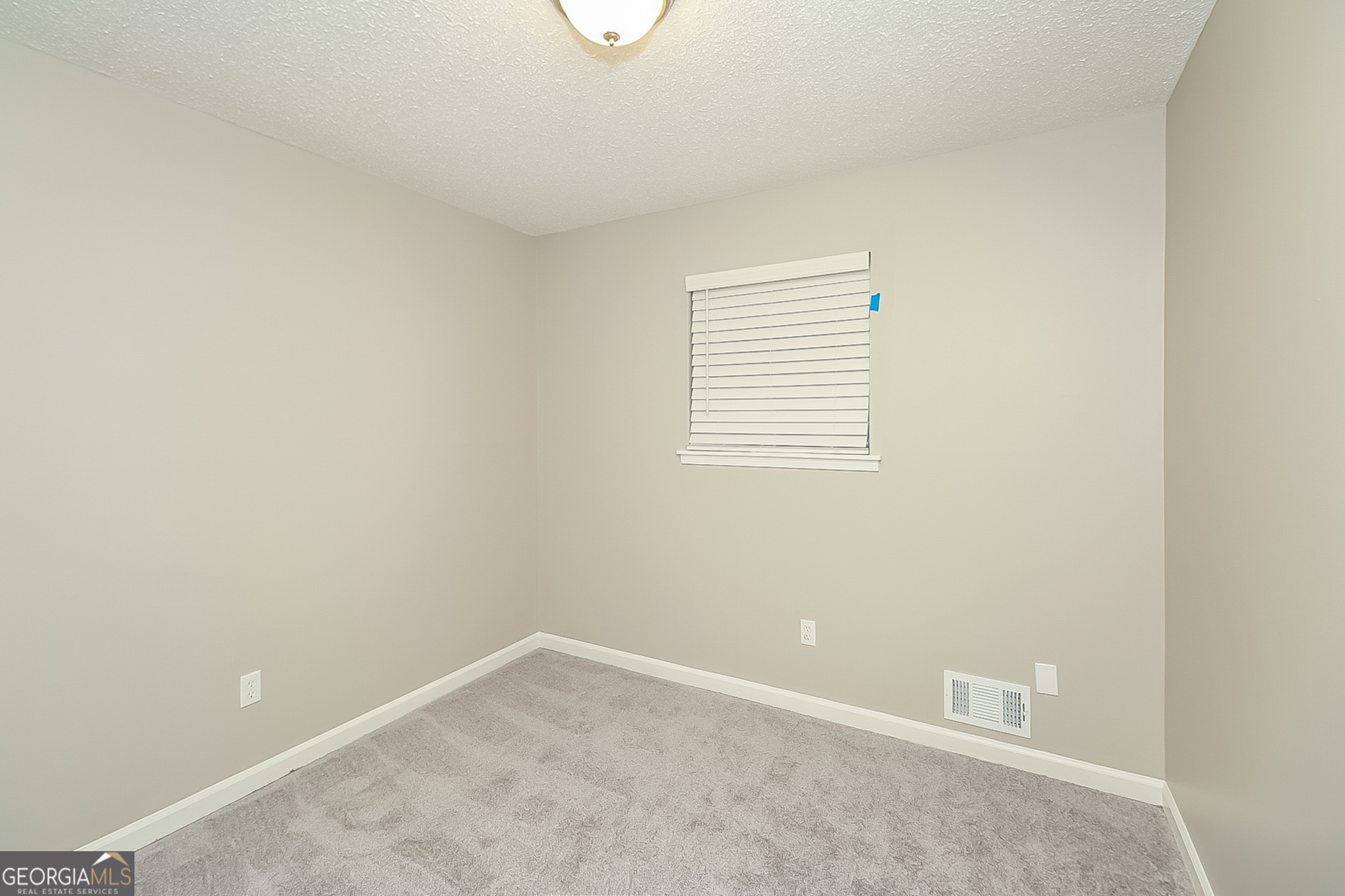 6745 Buckhurst Trail Atlanta, GA 30349 - Photo 11 of 17 a view of an empty room with a window