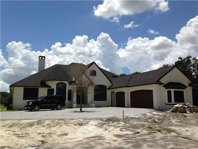5050 Hancock Road Southwest Ranches, FL 33330 - Photo 1 of 13 a front view of a house with a yard