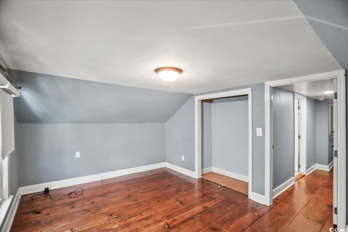 818 Evans Road Marion, SC 29571 - Photo 25 of 39 Additional living space with dark wood-style floors and vaulted ceiling