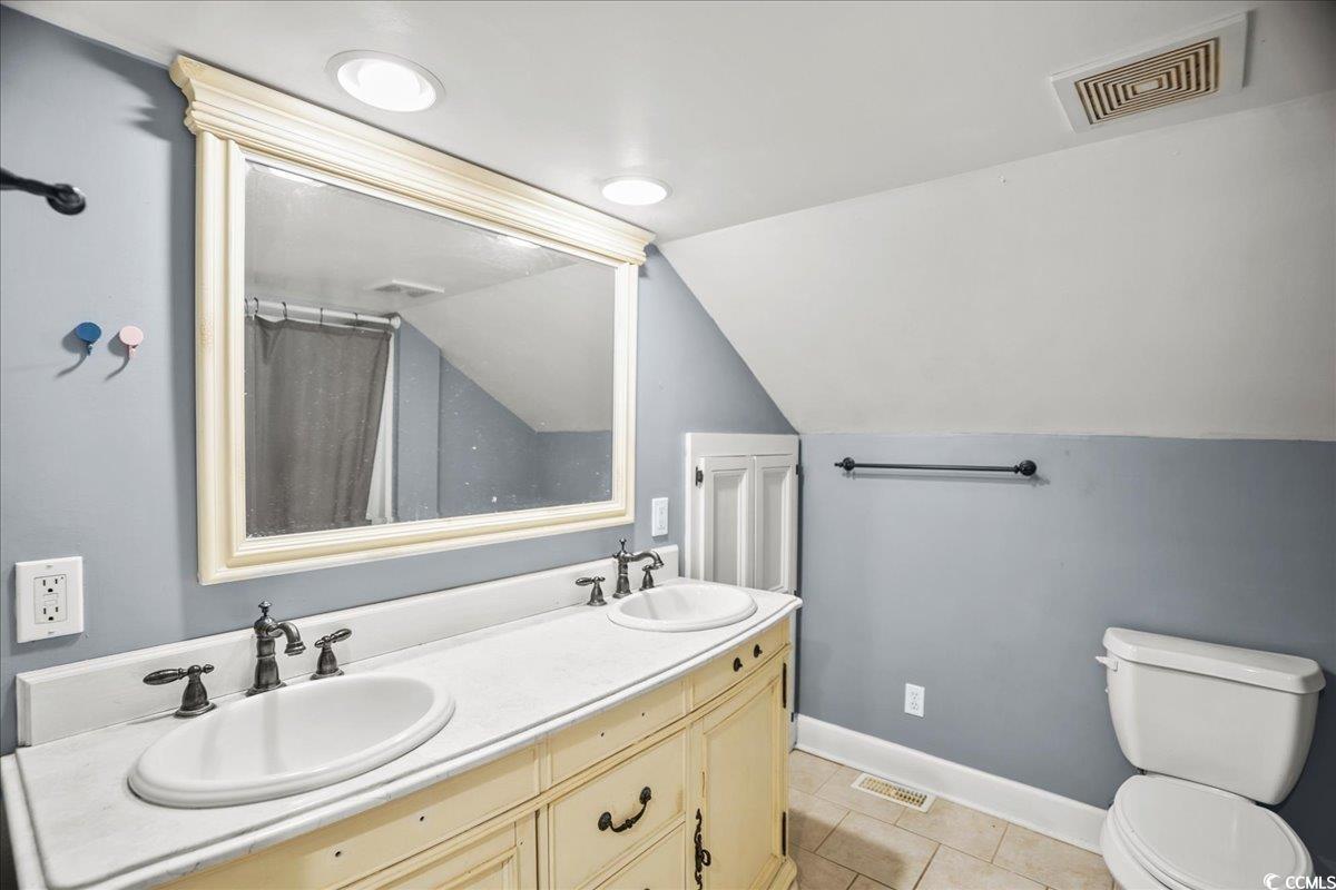 818 Evans Road Marion, SC 29571 - Photo 28 of 39 Bathroom with light tile patterned flooring, double vanity, a shower with shower curtain, and lofted ceiling