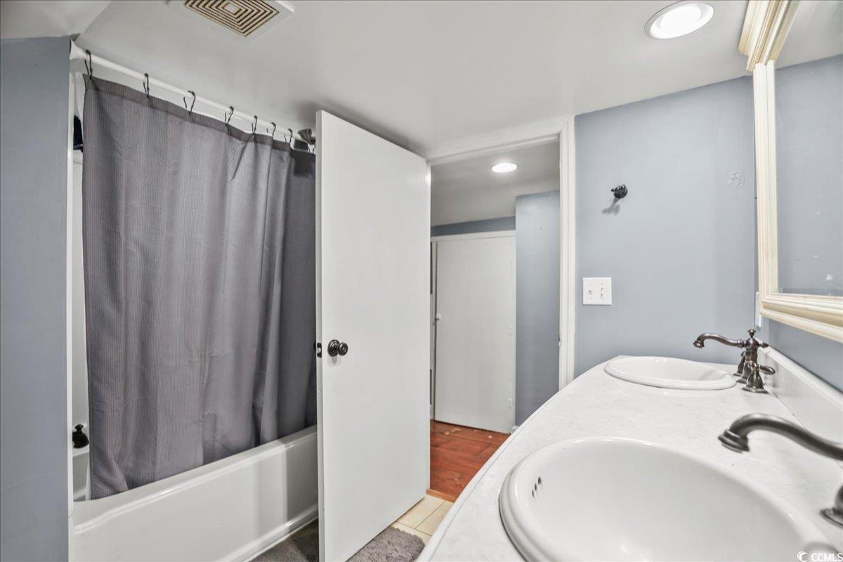 818 Evans Road Marion, SC 29571 - Photo 29 of 39 Bathroom featuring shower / bath combination with curtain and double vanity