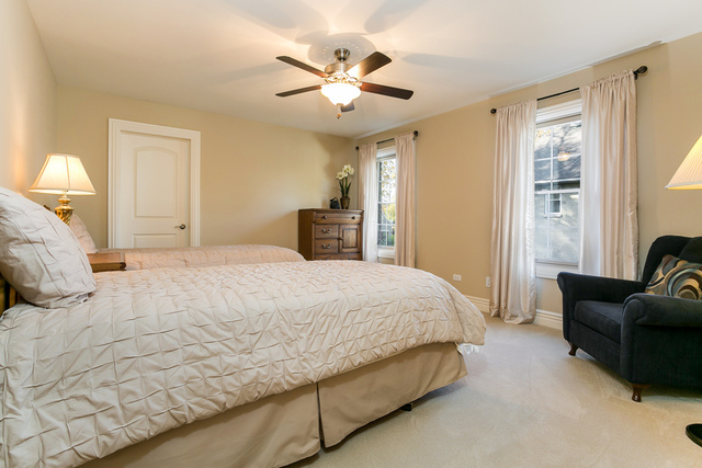 4553 Wolf Road Western Springs, IL 60558 - Photo 22 of 35 a bedroom with a large bed couch and a window