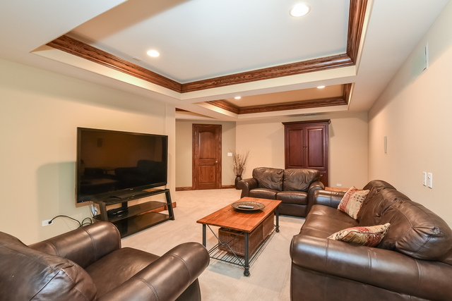 4553 Wolf Road Western Springs, IL 60558 - Photo 27 of 35 a living room with furniture and a flat screen tv