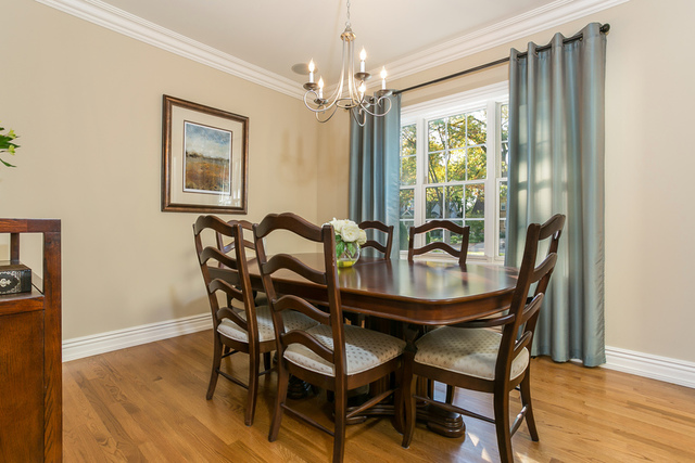 4553 Wolf Road Western Springs, IL 60558 - Photo 6 of 35 a dining room with furniture a chandelier and wooden floor