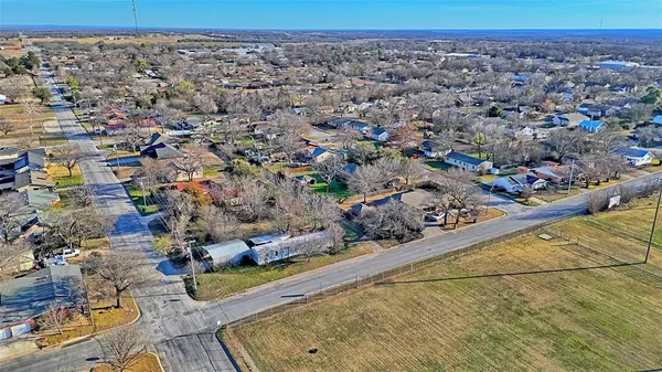 an aerial view of a residential houses with outdoor space